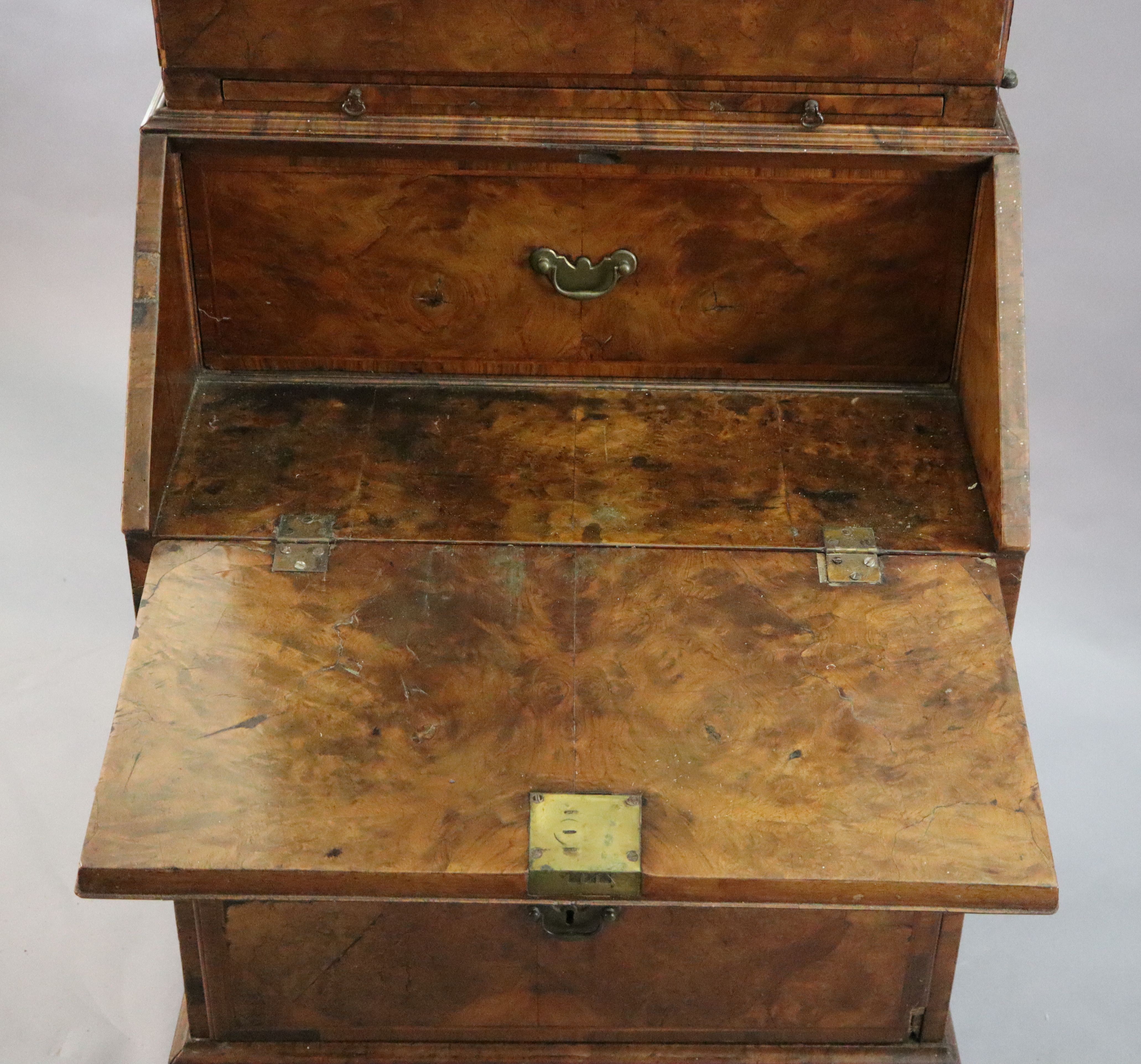 An early 18th century banded walnut bureau bookcase W. 2ft 4in. H. 6ft 6in. D. 1ft 8in.